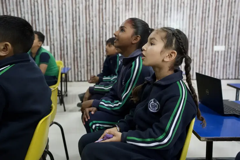 A man standing in front of a classroom full of students.